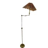 A FLOOR STANDING ADJUSTABLE ARTICULATED BRASS LAMP