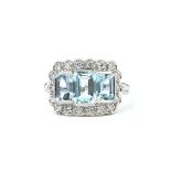 AN 18CT WHITE GOLD THREE STONE AQUAMARINE AND DIAMOND DRESS RING. (Aquamarine 2.10ct, Diamonds 0.