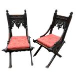 A PAIR OF 19TH CENTURY CARVED GOTHIC OAK HALL CHAIRS With pointed arched backs swept arms above