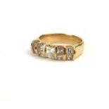 A 14CT GOLD AND DIAMOND CLUSTER RING, The central princess cut diamond flanked with two pairs of