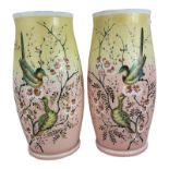 A PAIR OF EARLY 20TH CENTURY COLOURED GLASS VASES Hand painted with birds and flowers on a pink