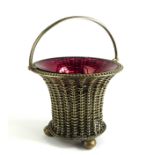 AN EARLY 20TH CENTURY WHITE METAL AND CRANBERRY GLASS BASKET Having a swing handle and basket