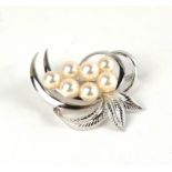 MIKIMOTO, A VINTAGE WHITE METAL AND PEARL BROOCH Organic leaf form set with an arrangement of