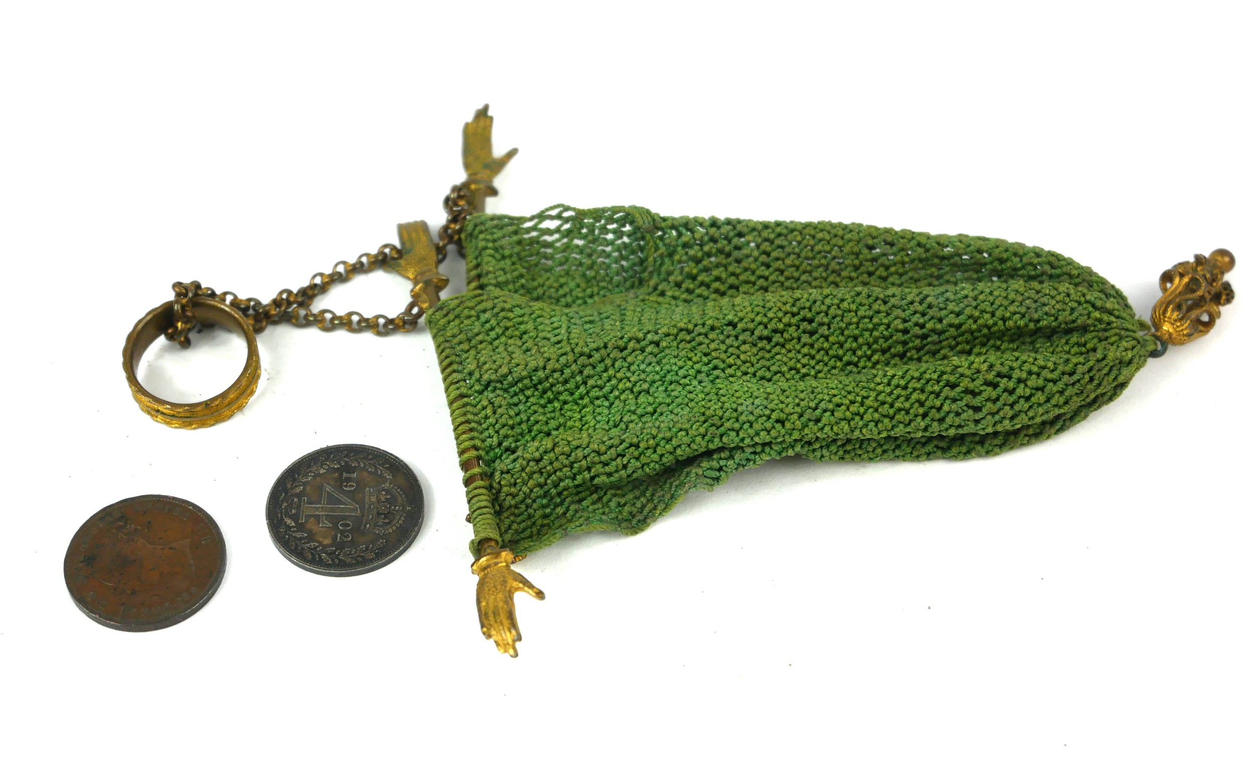 A 19TH CENTURY GILT METAL MISER'S PURSE Set with two pairs of hands and ring seal on green fabric