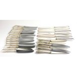 A COLLECTION OF FOURTEEN EARLY 20TH CENTURY WHITE METAL BUTTER KNIVES Having a reeded design and