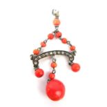 AN EDWARDIAN WHITE METAL, DIAMOND AND CORAL PENDANT Set with a row of rose cut diamonds and