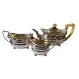 A GEORGIAN SILVER THREE PIECE TEA SET Comprising a teapot with ivory handle and finial, gadroon