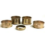 A COLLECTION OF EDWARDIAN SERVIETTE RINGS Comprising four Birmingham made ones and one made in