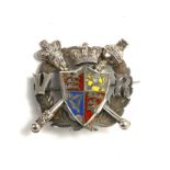 A VICTORIAN WHITE METAL AND ENAMEL ROYAL COMMEMORATIVE BROOCH Having a central armorial crest with