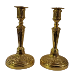 A PAIR OF VICTORIAN GILDED BRASS BALUSTER CANDLESTICKS Each with round sconce columns on circular