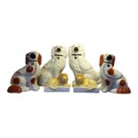 STAFFORDSHIRE, A PAIR OF 20TH CENTURY POTTERY MODELS, SEATED KING CHARLES SPANIELS Gilt detail and