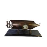 A LARGE BRONZE ZEPPELIN CLOCK ON BLACK MARBLE BASE Complete with pendulum and key. (h 38cm x