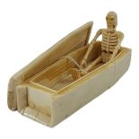 A POLISHED BONE COFFIN AND SKELETON Momento inscription to base. (length 12cm) Condition: good