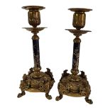 A PAIR OF FINE AESTHETIC MOVEMENT GILT BRONZE CANDLESTICKS Central column enamelled with plants on
