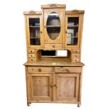 A 19TH CENTURY CONTINENTAL PINE DRESSER With three glazed doors above an arrangement of drawers