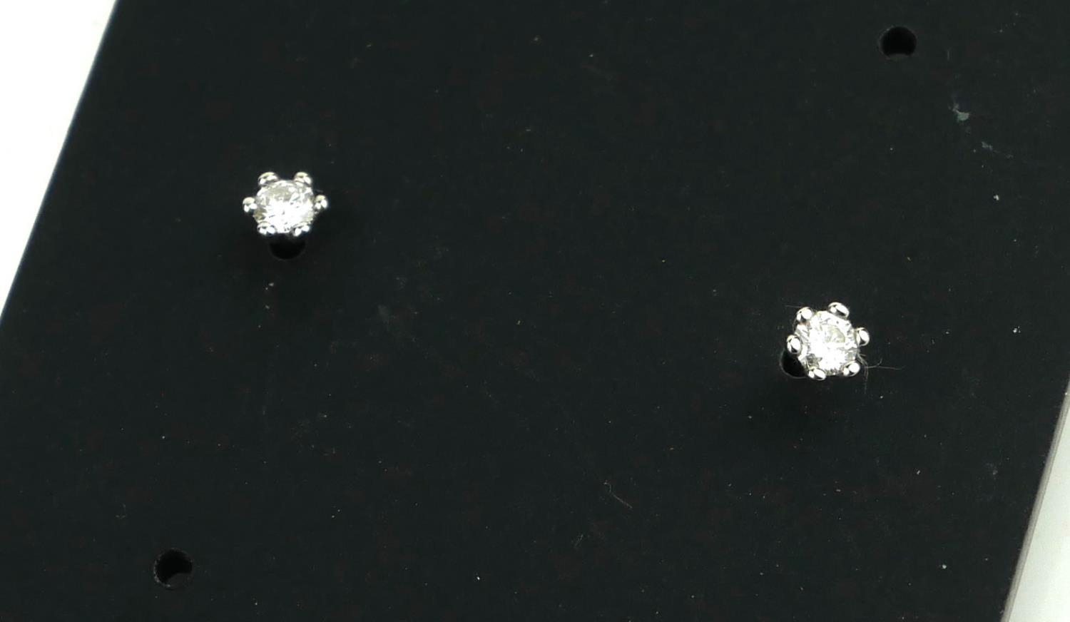 A PAIR OF 20TH CENTURY SILVER AND DIAMOND STUD EARRINGS Each set with a single round cut diamond. ( - Image 2 of 2