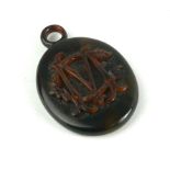 A VICTORIAN TORTOISE SHELL OVAL LOCKET With raised initials to centre. (approx 3.5cm x 5.5cm
