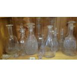 A MIXED COLLECTION OF MOSTLY EDWARDIAN CUT CRYSTAL GLASS DECANTERS AND STOPPERS All engraved with