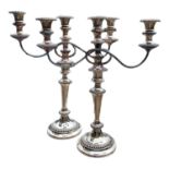 A PAIR OF EARLY 20TH CENTURY SILVER PLATED CANDELABRA Having three sconces with gadrooned border and