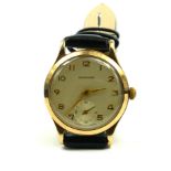 GARRARD, A VINTAGE 9CT GOLD GENT'S WRISTWATCH Silver tone dial with gilt number markings and