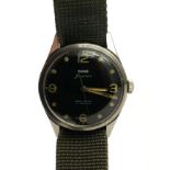 HMT JAWAN, A VINTAGE STAINLESS STEEL MILITARY ISSUE GENT'S WRISTWATCH Having a circular black dial