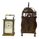 A MID 20TH CENTURY BRASS LANTERN STYLE CLOCK The raised pierced crest above decorated with dolphins,