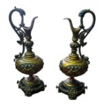 A PAIR OF 19TH CENTURY CONTINENTAL CAST METAL AND BRONZED CELLINI PATTERN EWERS Both having