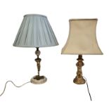 TWO CHERUB FORM BEDROOM LAMP BASES One with gilded brass, raised on an onyx base, both complete with