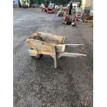 A WOODEN WHEELBARROW with body extensions. Condition good some wear