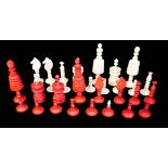 A NINETEEN CENTURY ANGLO INDIAN IVORY CHESS SET Red stained and plain ivory pieces in a burgundy