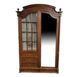 A LATE 19TH CENTURY FRENCH OAK DOUBLE ARMOIRE Having arch cornice acorn finials, bevelled mirrored