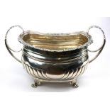 A GEORGIAN IRISH SILVER SUGAR BASIN Twin handled, gadrooned, masks to border and flutes to body,