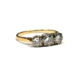 AN EARLY 20TH CENTURY 18CT GOLD AND DIAMOND THREE STONE RING Graduated stones in an illusion set