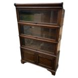 AN EARLY 20TH CENTURY OAK FOUR SECTION GLOBE WERNICKE BOOKCASE With three glazed sections and