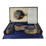 AN EARLY 20TH CENTURY SILVER AND TORTOISESHELL DRESSING TABLE/VANITY SET Comprising a hand mirror,