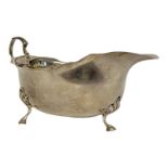 WALKER AND HALL, A 20TH CENTURY GEORGIAN STYLE SILVER SAUCE BOAT On three feet, hallmarked W&H,