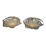 A PAIR OF VINTAGE SILVER HEXAGONAL SWEETMEAT BASKETS With swing handles and pierced scrolled