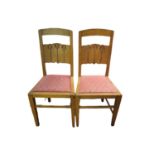 IN THE MANNER OF CHARLES VOYSEY, 1857 - 1941, A PAIR OF OAK ARTS & CRAFTS CHAIRS Having carved