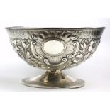A GEORGIAN IRISH SILVER OVAL SUGAR BASIN With embossed floral decoration and cartouche, on a