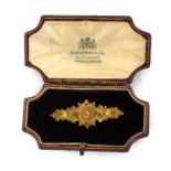 A 19TH CENTURY 9CT YELLOW GOLD BROOCH IN ORIGINAL BOX With a solitaire central diamond, leaves and