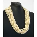 A MID 20TH CENTURY FRESHWATER PEARL NECKLACE Having a 9ct yellow gold circular pierced clasp,