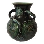 A LATE 19TH CENTURY BRANNAM BARNSTAPLE DEVON GLOBULAR POTTERY VASE With three swirling handles,