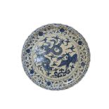 A VERY LARGE CERAMIC CHINESE BLUE AND WHITE DECORATED CHARGER PLATE Depicting a dragon and