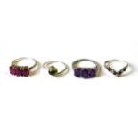 A VINTAGE SILVER AND RUBY THREE STONE RING The oval cut stones on a plain shank, together with a