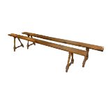 A PAIR OF 19TH CENTURY FRENCH FRUITWOOD BENCHES The single plank seat, raised on four turned