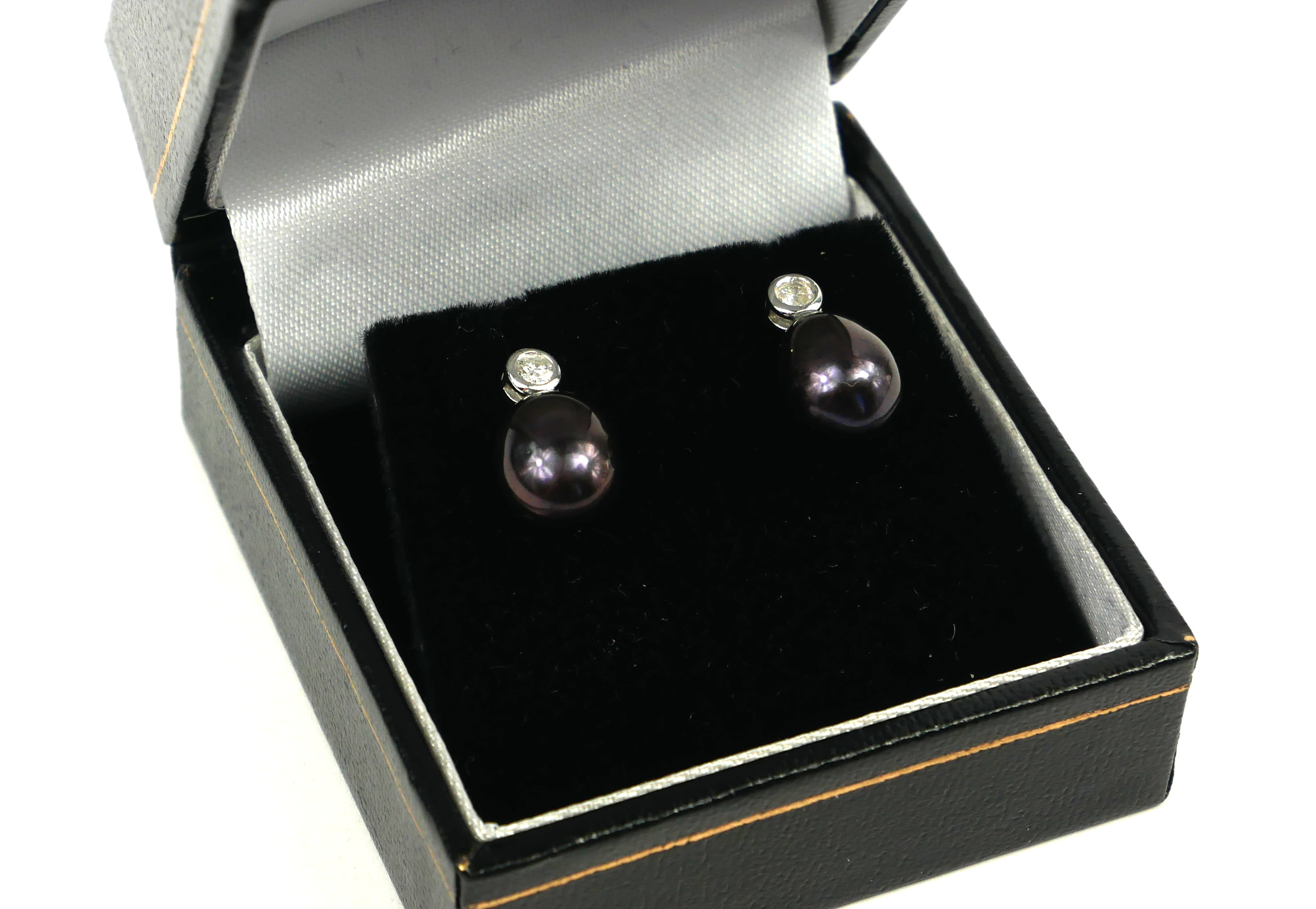 A PAIR OF 9CT WHITE GOLD, BLACK PEARL AND DIAMOND RUBOVER DROP EARRINGS. Boxed