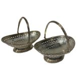 MAPPIN & WEBB, A PAIR OF SILVER SWING HANDLED BASKETS Having bead and pierced decoration raised upon