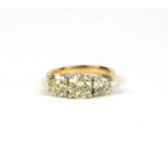 AN 18CT WHITE AND YELLOW GOLD ROUND BRILLIANT CUT DIAMOND TRILOGY RING, with WGI certificate. (