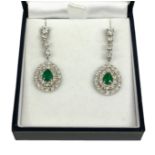 A PAIR OF 18CT WHITE GOLD PEAR DROP EMERALD AND DIAMOND CLUSTER DROP EARRINGS, Boxed. (Approx