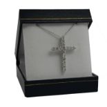 AN 18CT WHITE GOLD CROSS SET WITH ROUND BRILLIANT CUT DIAMONDS ON AN 18CT WHITE GOLD CHAIN,